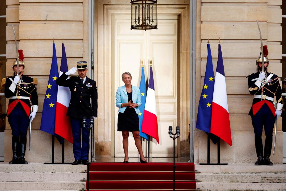 Newly-appointed French Prime Minister Elisabeth Borne attends a handover ceremony in the courtyard of Hotel Matignon in Paris, France, May 16, 2022. REUTERSpix