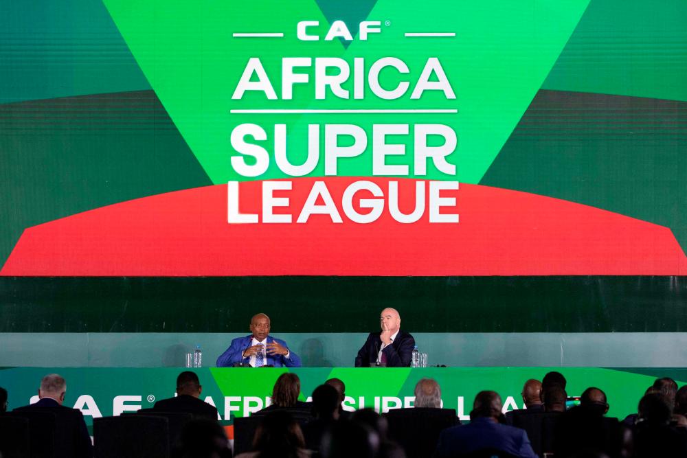FIFA president Gianni Infantino (R) and Confederation of Africa Football (CAF) Patrice Motsepe (L) attends the CAF 44th General assembly at the Arusha International Conference Centre in Arusha on August 10, 2022. AFPPIX