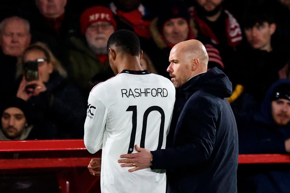 Manchester United's Dutch manager Erik ten Hag (R) conforts Manchester United's English striker Marcus Rashford (L) as he leaves the pitch following an injury during the English League Cup semi-final first-leg football match between Nottingham Forest and Manchester United, at The City Ground stadium, in Nottingham, central England, on January 25, 2023/AFPPIX