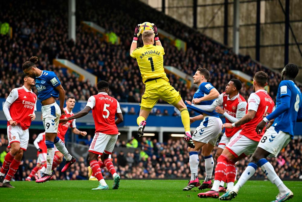 Arsenal’s English goalkeeper Aaron Ramsdale jumps to catch the ball during the English Premier League football match between Everton and Arsenal at Goodison Park in Liverpool, north-west England, on February 4, 2023/AFPPix