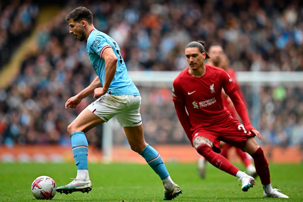 Manchester City’s Portuguese defender Ruben Dias (L) vies with Liverpool’s Uruguayan striker Darwin Nunez (R) during the English Premier League football match between Manchester City and Liverpool at the Etihad Stadium in Manchester, north west England, on April 1, 2023/AFPPix