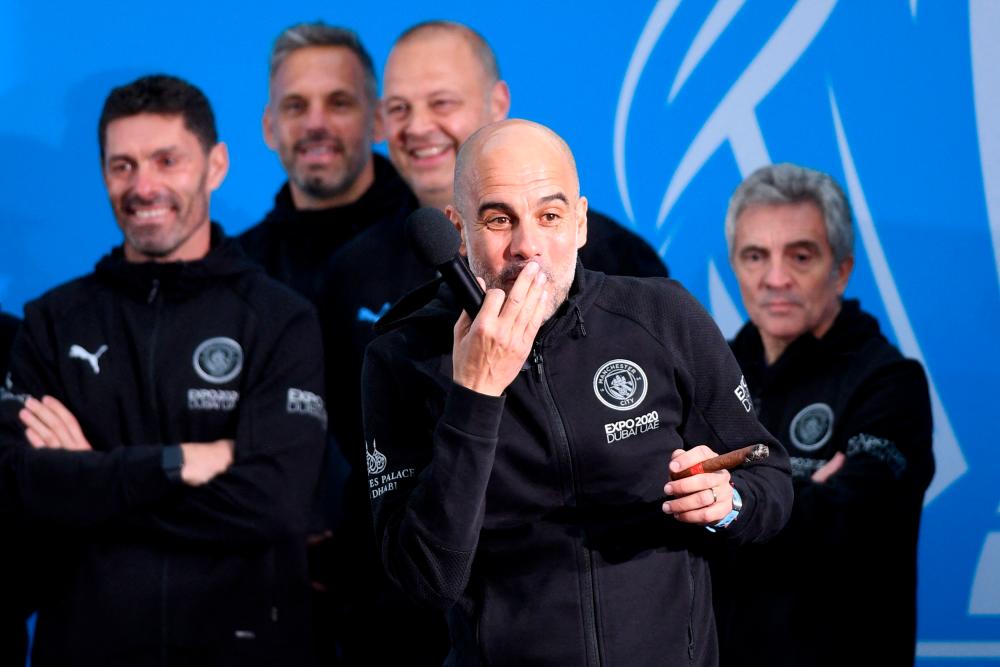 Manchester City’s Spanish manager Pep Guardiola (C) attends an event for fans with members of the Manchester City football team following an open-top bus parade through Manchester, north-west England on May 23, 2022, to celebrate winning the 2021-22 Premier League title. AFPPIX