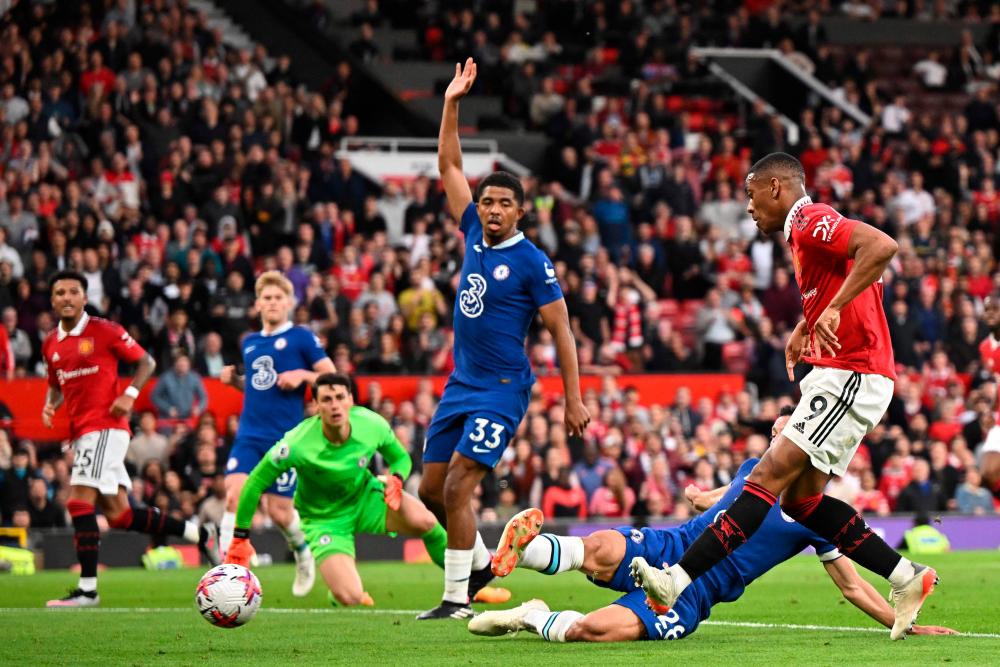 Manchester United’s French striker Anthony Martial (R) shoots to score their second goal during the English Premier League football match between Manchester United and Chelsea at Old Trafford in Manchester, north west England, on May 25, 2023/AFPPix