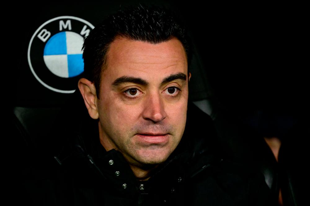 Barcelona’s Spanish coach Xavi looks on before the start of the Copa del Rey (King’s Cup) semi final first Leg football match between Real Madrid CF and FC Barcelona at the Santiago Bernabeu stadium in Madrid on March 2, 2023. AFPPIX