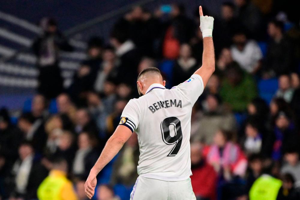 Real Madrid's French forward Karim Benzema celebrates after scoring his team's third goal during the Spanish League football match between Real Madrid CF and Elche CF at the Santiago Bernabeu stadium in Madrid on February 15, 2023. AFPPIX