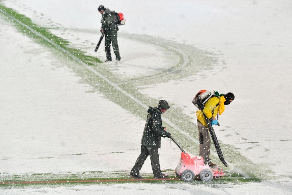 Stadium employees blow the snow covering the pitch ahead of the UEFA Champions League Group F football match between Atalanta and Villarreal on December 8, 2021 at the Atleti Azzurri d'Italia stadium in Bergamo. AFPpix