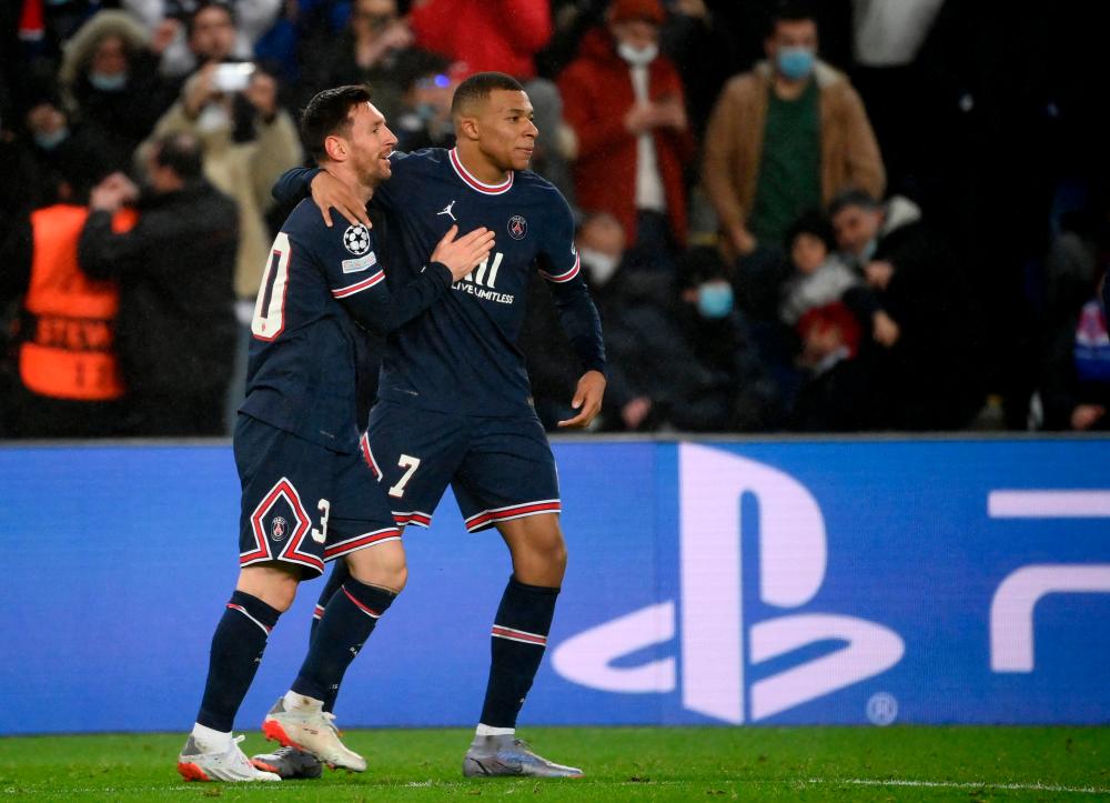 Paris Saint-Germain's Argentinian forward Lionel Messi (L) is congratulated by Paris Saint-Germain's French forward Kylian Mbappe (R) after scoring a goal during the UEFA Champions League first round day 6 Group A football match between Paris Saint-Germain (PSG) and Club Brugge, at the Parc des Princes stadium in Paris on December 7, 2021. AFPpix