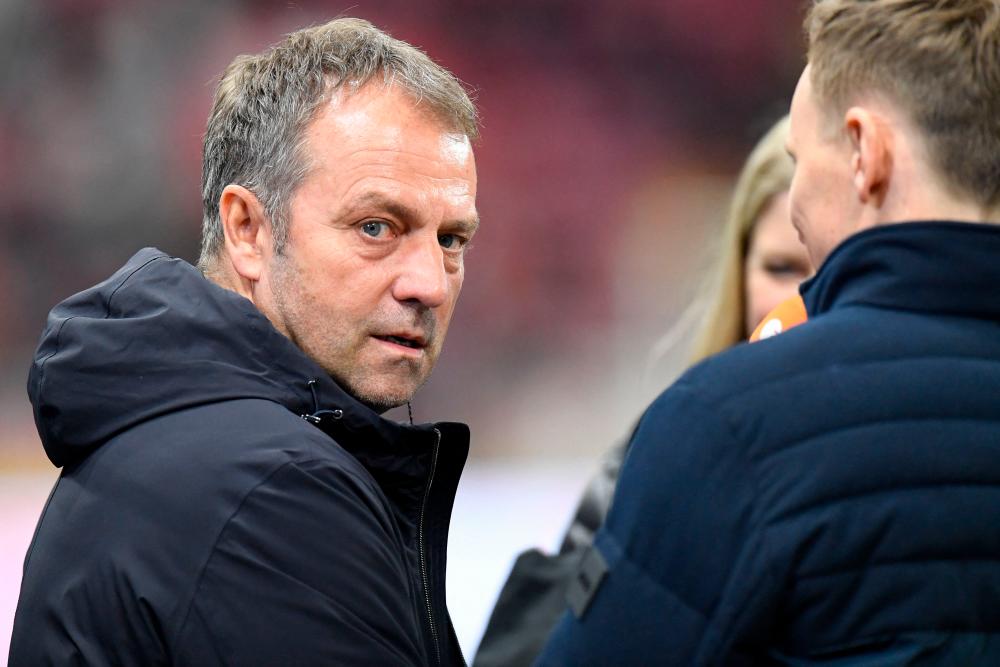 Germany’s coach Hans-Dieter Flick (L) is interviewed prior to the international friendly football match Germany v Peru in Mainz, southern Germany, on March 25, 2023. AFPPIX