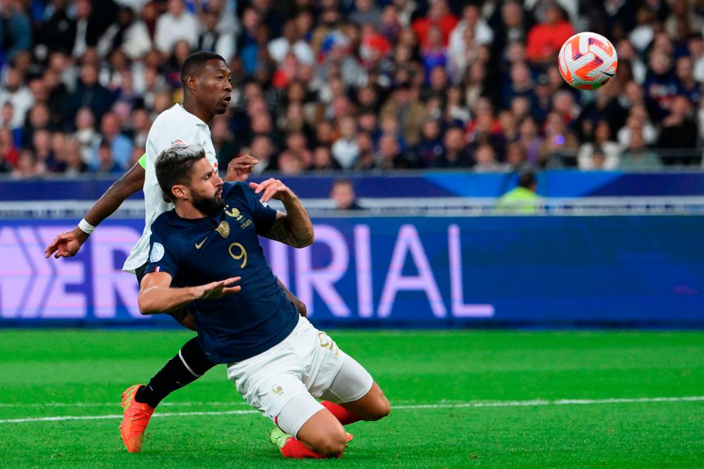 France's forward Olivier Giroud (R) controls the ball ahead of Austria's defender and captain David Alaba during the UEFA Nations League, League A Group 1 football match between France and Austria at Stade de France in Saint-Denis, north of Paris, on September 22, 2022. AFPPIX
