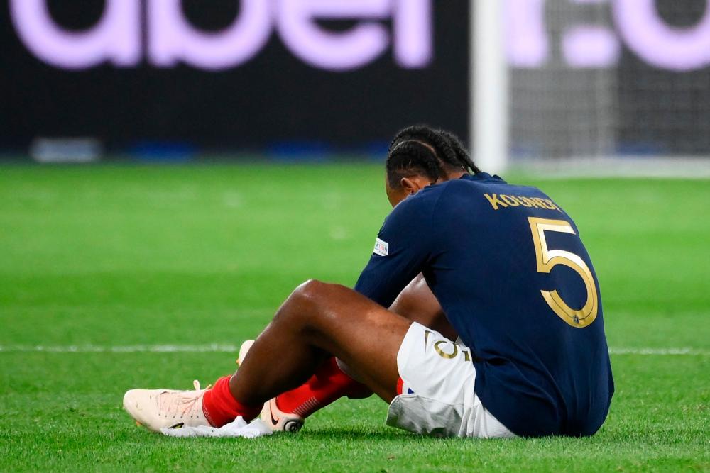 France’s defender Jules Kounde sits on the pitch after injury during the UEFA Nations League, League A Group 1 football match between France and Austria at Stade de France in Saint-Denis, north of Paris, on September 22, 2022. AFPPIX