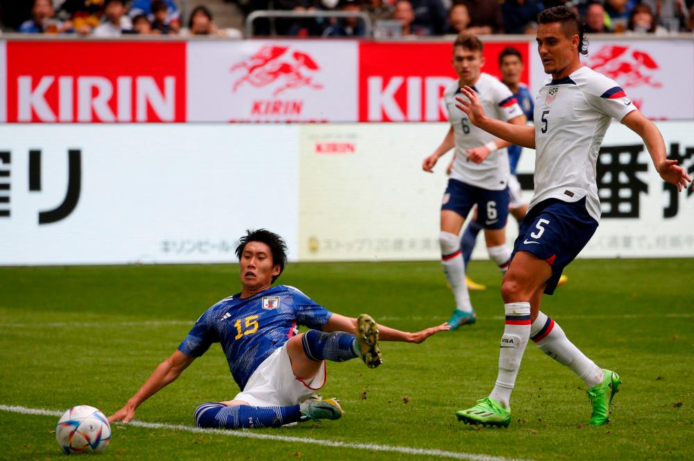 Japan’s forward Daichi Kamada (L) and United States’ defender Aaron Long vie for the ball during the friendly football match between Japan and United States in Dusseldorf, western Germany/AFPPix