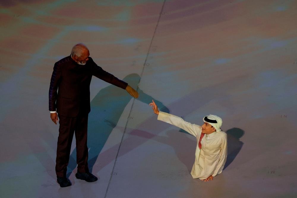 $!US actor Morgan Freeman (left) and Qatari YouTuber Ghanim al Muftah attend the opening ceremony on November 20, 2022. – AFPPIX