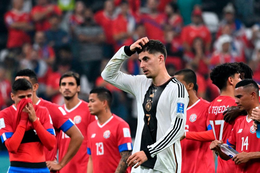 Germany's midfielder #07 Kai Havertz (C) gestures next to Costa Rica's players at the end of the Qatar 2022 World Cup Group E football match between Costa Rica and Germany at the Al-Bayt Stadium in Al Khor, north of Doha on December 1, 2022. AFPPIX