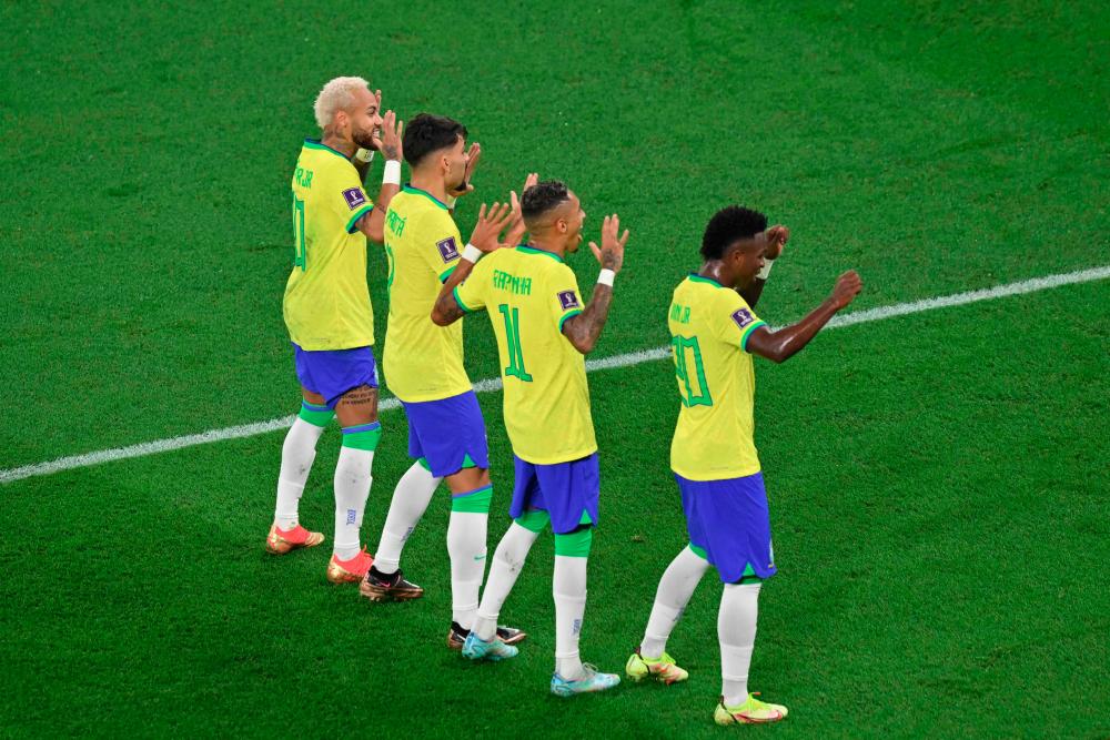 Vinicius Junior celebrates scoring his team's first goal with Raphinha, Lucas Paqueta, and Neymar during the Qatar 2022 World Cup round of 16 match between Brazil and South Korea at Stadium 974 in Doha on December 5, 2022. AFPPIX