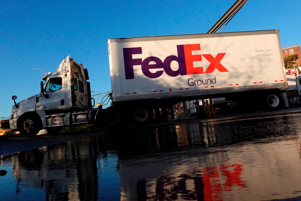 A FedEx delivery truck exits a facility in Brooklyn, New York City. FedEx plans to raise average rates by 6.9% starting on Jan 2. – Reuterspix