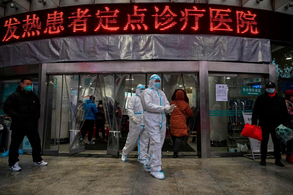 This file photo taken January 25, 2020 shows medical staff members, wearing protective clothing at the Wuhan Red Cross Hospital in Wuhan, as the city struggled with the outbreak of the once-mysterious virus which eventually killed millions globally. AFPPIX