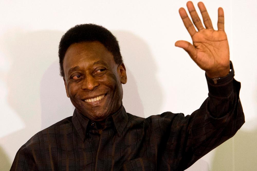 In this file photo taken on March 12, 2015, Brazilian football legend Edson Arantes do Nascimento, known as “Pele”, waves during the autograph ceremony of his book “Segundo Tempo” (Second Half), in Santos, some 70 km from Sao Paulo, Brazil/AFPPix