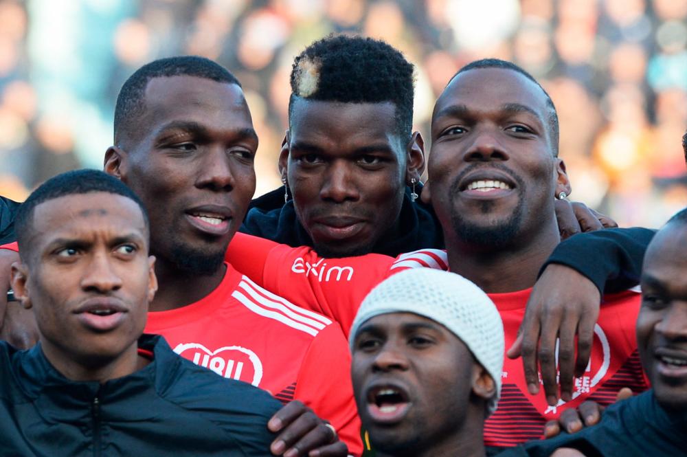 (FILES) In this file photo taken on December 29, 2019, the Pogba brothers, Manchester United and France midfielder Paul Pogba (C), Atlanta United defender Florentin Pogba (L) and CD Manchego midfielder Mathias Pogba (R), pose prior to a gala football match between All Star France and Guinea at the Vallee du Cher Stadium in Tours, central France, as part of the “48h for Guinea” charity event. AFPPIX