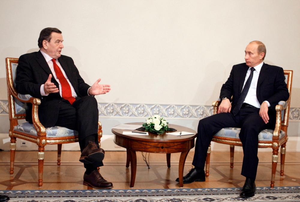 (FILES) In this file photo taken on January 7, 2009 then Russian Prime Minister Vladimir Putin (R) speaks with then North European Gas Pipeline Chairman Gerhard Schroeder during their meeting in St Petersburg, Russia. AFPPIX