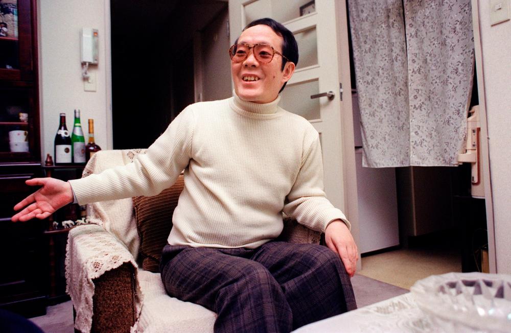 This file photo taken on February 5, 1992 shows former Japanese student Issei Sagawa, known as the “Kobe Cannibal” for killing and then devouring a Dutch student in 1981, smiling and gesturing as he meets with an AFP journalist at his apartment in Yokohama. AFPPIX