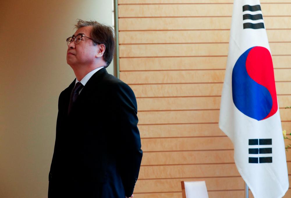 (FILES) This file photo taken on March 13, 2018 shows then South Korea's National Intelligence Service chief Suh Hoon waiting for the arrival of Japan's Prime Minister Shinzo Abe (not pictured) prior to their meeting in Tokyo. South Korea on December 3, 2022 arrested Suh Hoon, a former national security chief, on suspicion of covering up events surrounding the 2020 murder of a fisheries official by Pyongyang. - AFPPIX