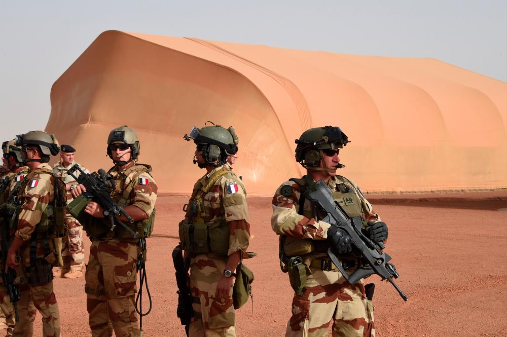French soldiers of the detachment of the Operation Barkhane standing outside the French base in the northern Malian city of Gao. — AFP