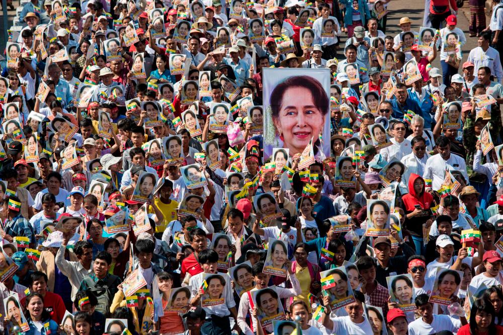 (FILES) In this file photo taken on December 10, 2019, people participate in a rally in support of Myanmar's State Counsellor Aung San Suu Kyi, as she prepares to defend Myanmar at the International Court of Justice in The Hague against accusations of genocide against Rohingya Muslims, in Yangon. AFPPIX