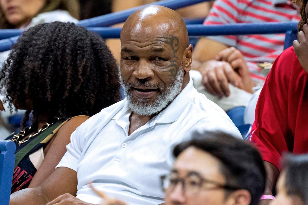 (FILES) In this file photo taken on September 02, 2022 Former US professional bozer Mike Tyson (C) attends the 2022 US Open Tennis tournament men's singles third round match between Russia's Daniil Medvedev and China's Wu Yibing at the USTA Billie Jean King National Tennis Center in New York. AFPPIX