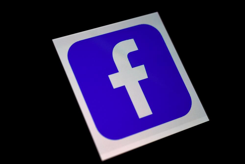 FILES) In this file illustration photo taken on March 25, 2020 a Facebook App logo is displayed on a smartphone in Arlington, Virginia. / AFP / Olivier DOULIERY