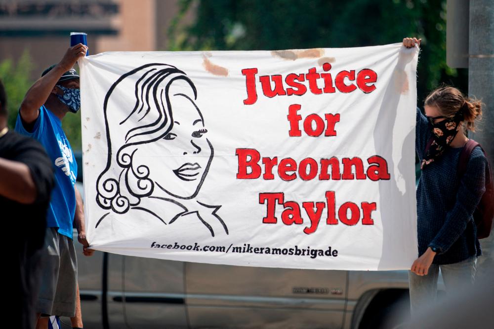 (FILES) In this file photo taken on September 19, 2020 community members gathered for a Stand 4 Breonna event to demand justice for Breonna Taylor in Austin, Texas. AFPPIX