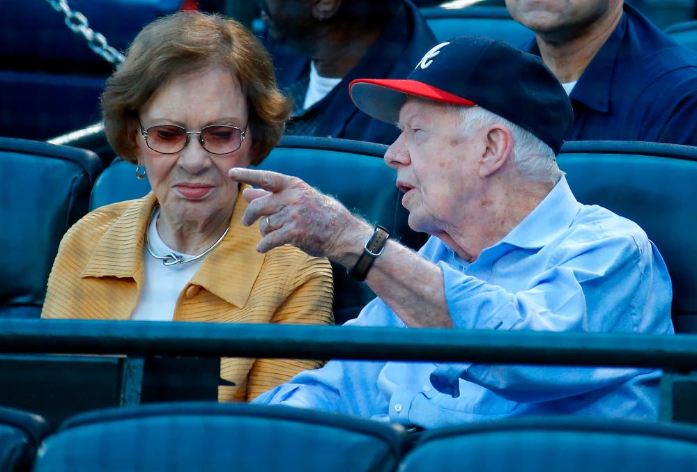 Filepix: Former President Jimmy Carter and his wife Rosalynn look on prior to the game between the Atlanta Braves and the Toronto Blue Jays at Turner Field on September 17, 2015 in Atlanta, Georgia/AFPPix
