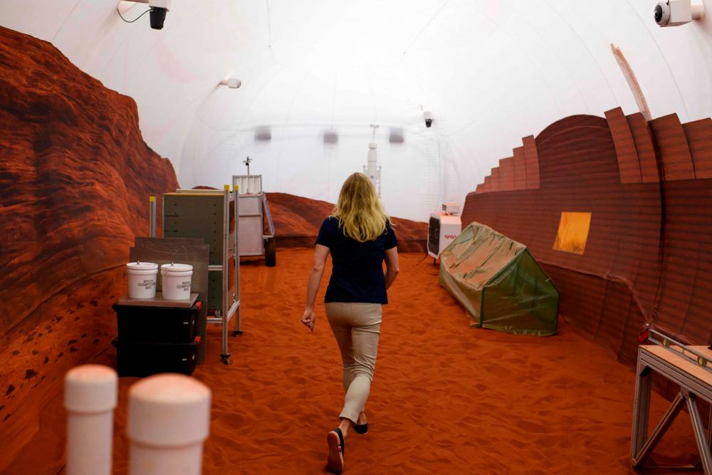 Dr. Suzanne Bell, Lead for NASA’s Behavioral Health and Performance Laboratory, walks through a simulated Mars exterior portion of the CHAPEA’s Mars Dune Alpha at the Johnson Space center in Houston, Texas on April 11, 2023. AFPPIX