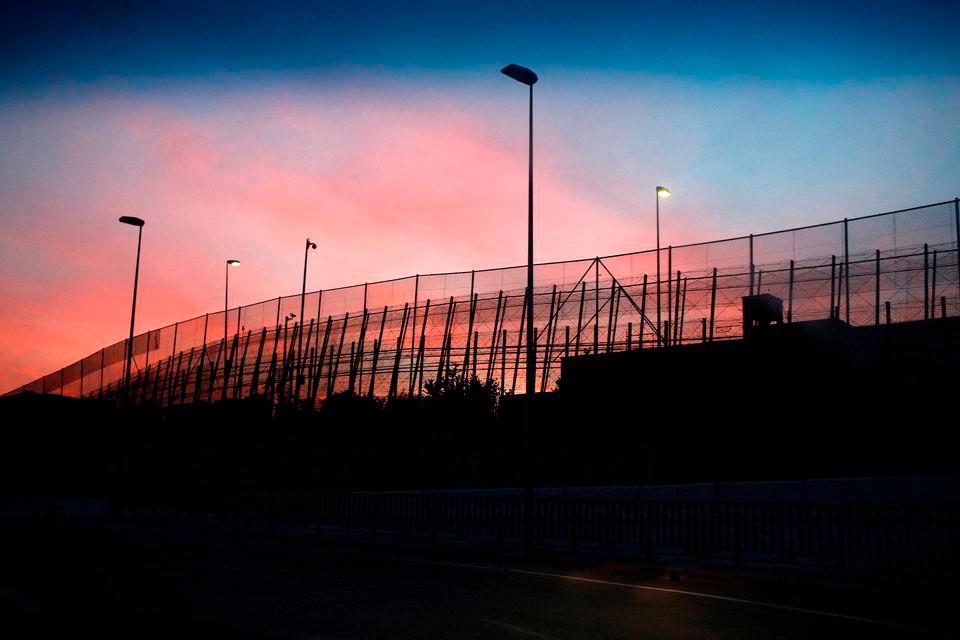 The border fence between Morocco and Spain’s north African enclave Melilla is seen along a road, December 11, 2014. REUTERS/pix