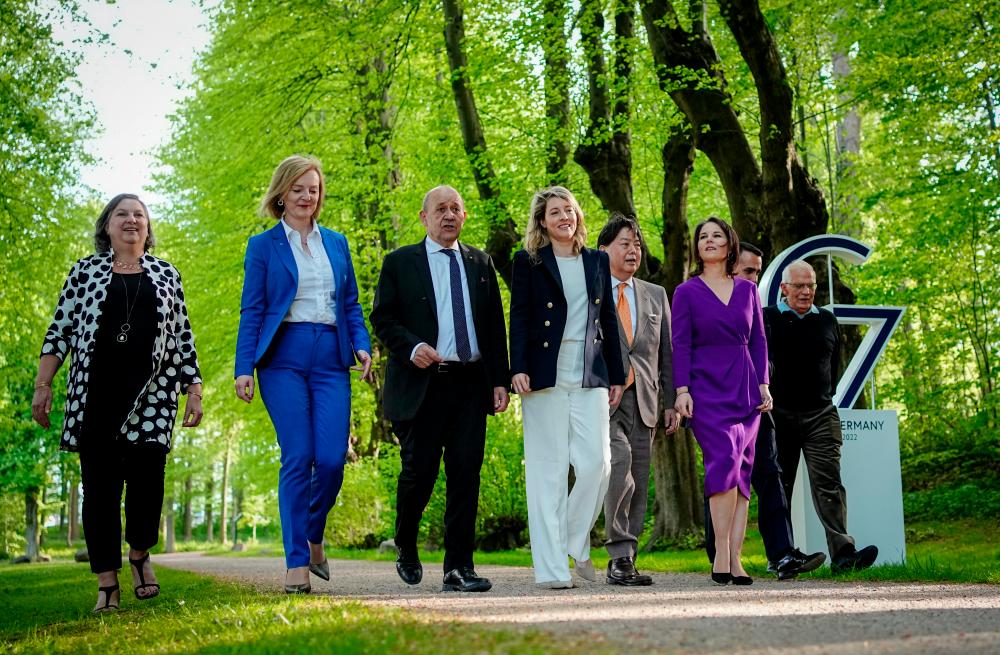 G7 countries foreign ministers walk for dinner during their summit in Weissenhaeuser Strand, Germany May 12, 2022. Foreign ministers pictured: Elizabeth Truss of Britain, Jean-Yves Le Drian of France, Melanie Joly of Canada, Annalena Baerbock of Germany, Hayashi Yoshimasa of Japan, Luigi Di Maio of Italy, Josep Borrell, head of EU foreign policy and Victoria Nuland of U.S., under secretary of state for political affairs. Kay Nietfeld/Pool via REUTERSpix