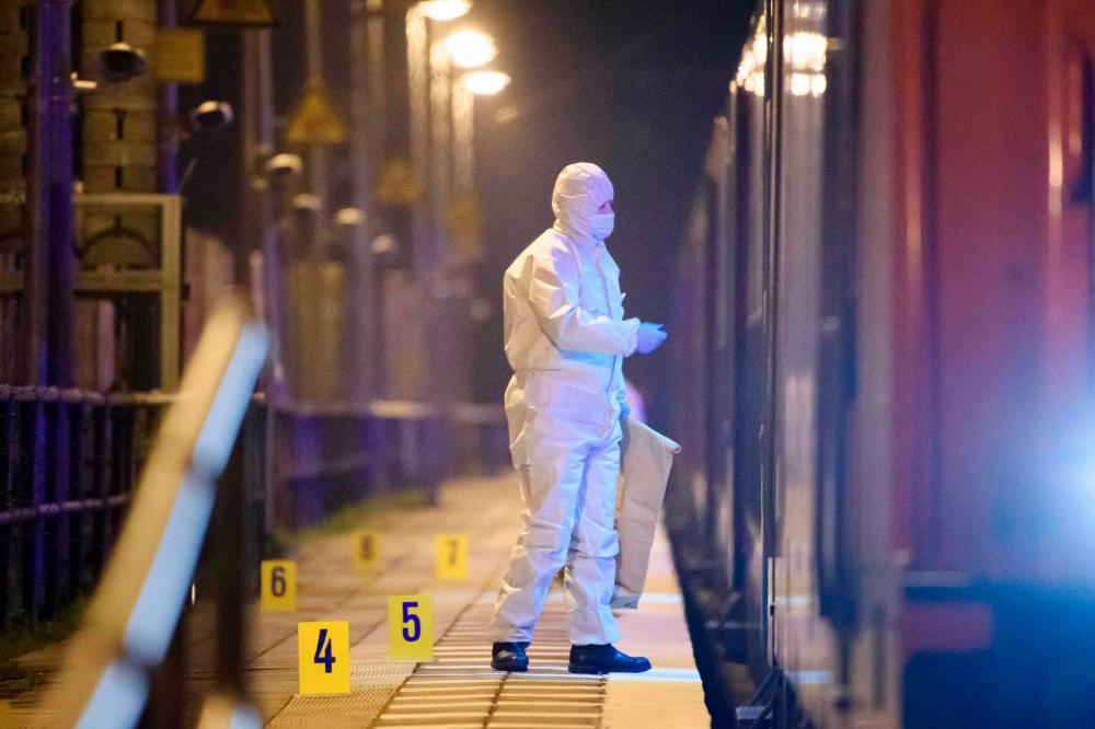 Forensic police secure evidence at the Brokstedt train platform after the knife attack. (AFP pic)