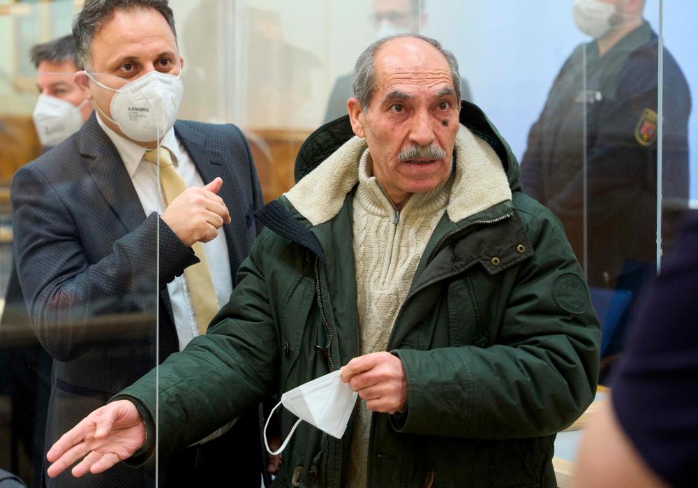 The defendant, former Syrian intelligence officer Anwar Raslan (R), gestures next to one of his lawyers in the courtroom at a courthouse in Koblenz, western Germany/AFPPix