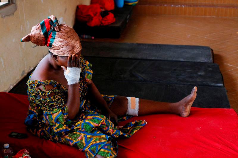 Nancy Nyarko, 51, sits at a shelter for displaced survivors after receiving medical attention for wounds suffered when a vehicle carrying mining explosives detonated along a road in Apiate near Bogoso, Ghana, January 22, 2022. REUTERSpix