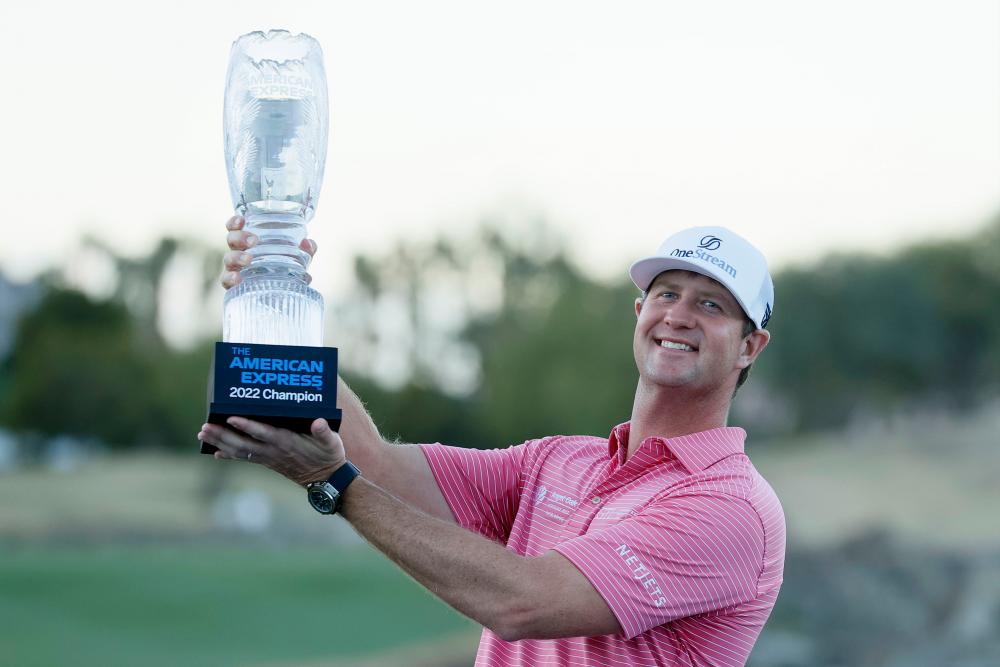 LA QUINTA, CALIFORNIA - JANUARY 23: Hudson Swafford celebrates with the winner’s trophy after winning The American Express at the Stadium Course at PGA West on January 23, 2022 in La Quinta, California. AFPPIX