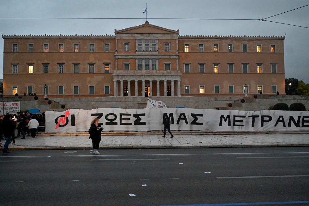 Protesters hold a giant banner translating into “our lives matter” during a protest in front of the Greek parliament in Athens, on March 2, 2023, following the deadly accident near the city of Larissa on February 28 which claimed 57 lives. AFPPIX
