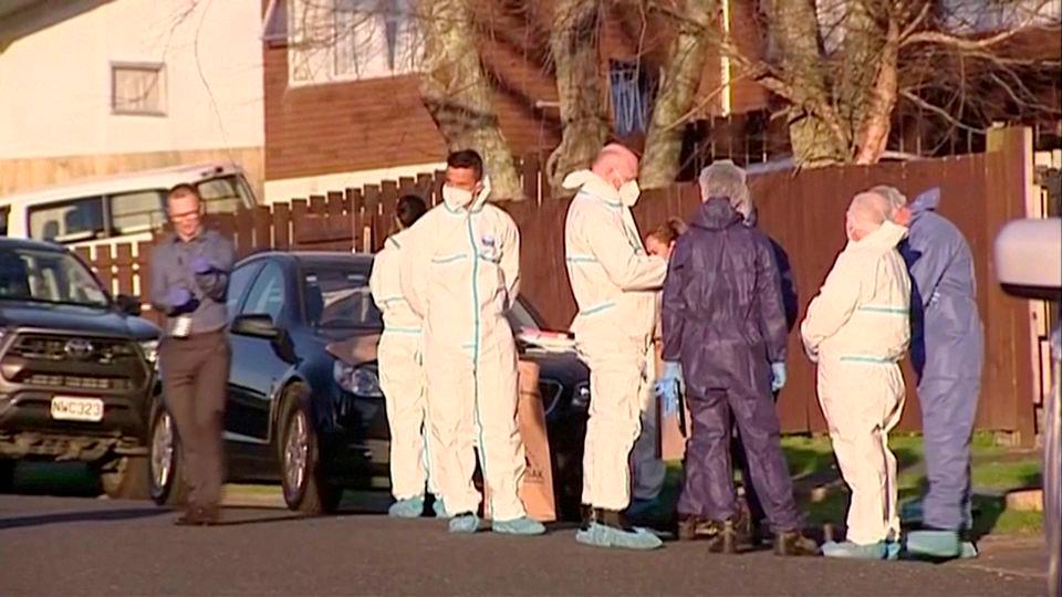 Police and forensic investigators gather at the scene where suitcases with the remains of two children were found, after a family, who are not connected to the deaths, bought them at an online auction for an unclaimed locker, in Auckland, New Zealand, August 11, 2022 in this still image taken from video. REUTERSPIX