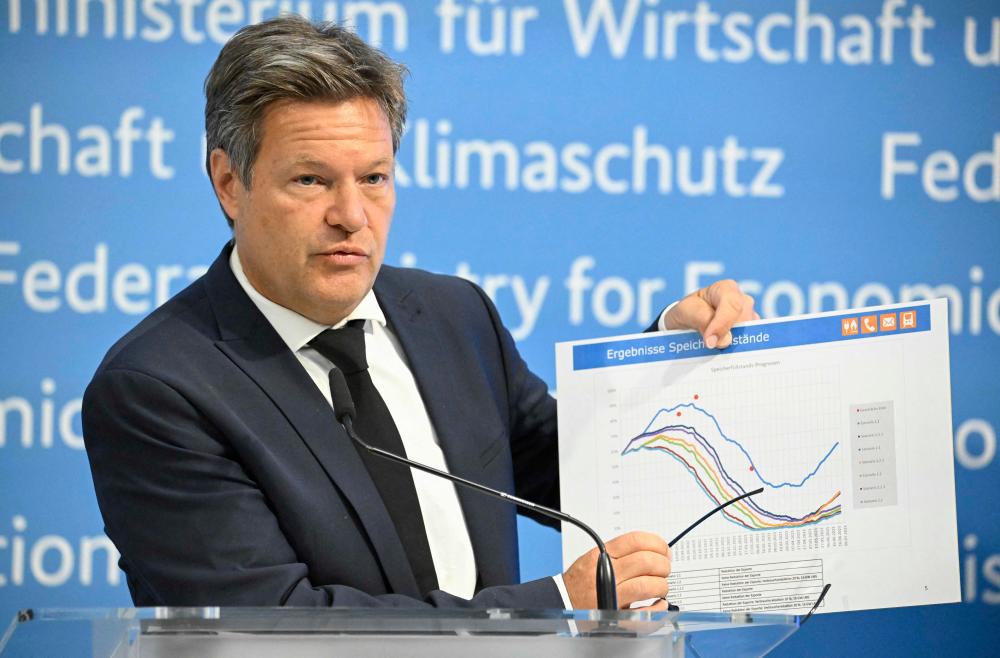 Habeck showing a graph featuring forecasts of storage levels at a press conference on energy supply security at his ministry in Berlin yesterday. AFPpix
