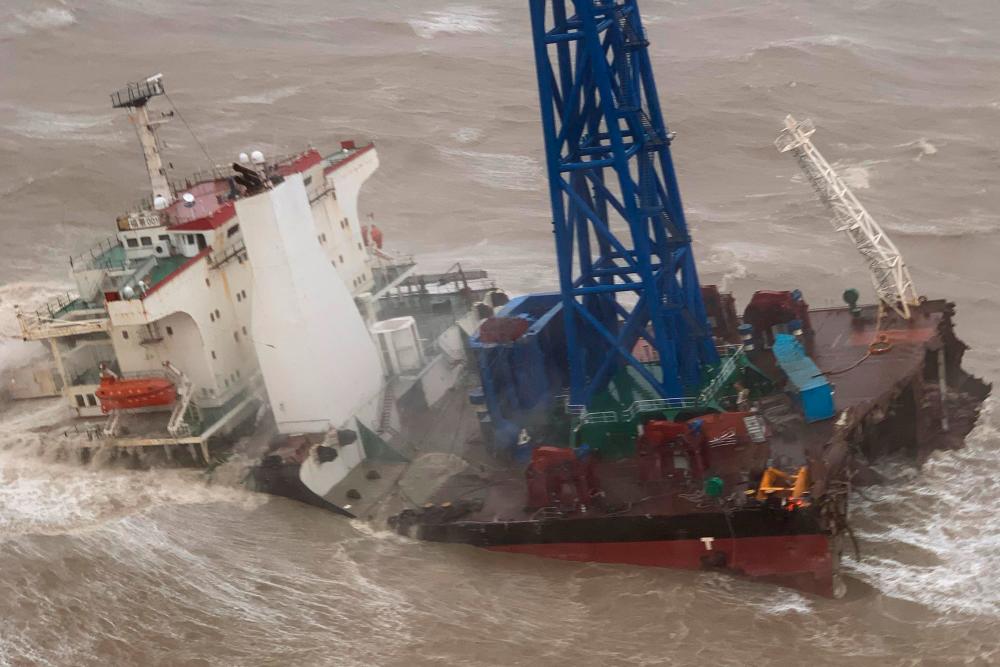 This handout photo taken and released by the Hong Kong Government Flying Service on July 2, 2022 shows a ship after it broke into two amid Typhoon Chaba, during a rescue operation of the crew members in the South China Sea 160 nautical miles southwest of Hong Kong. AFPPIX