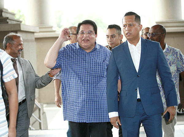 Filepix taken on July 2 shows Datuk Seri Tengku Adnan Tengku Mansor (center) arriving at Kuala Lumpur courts complex