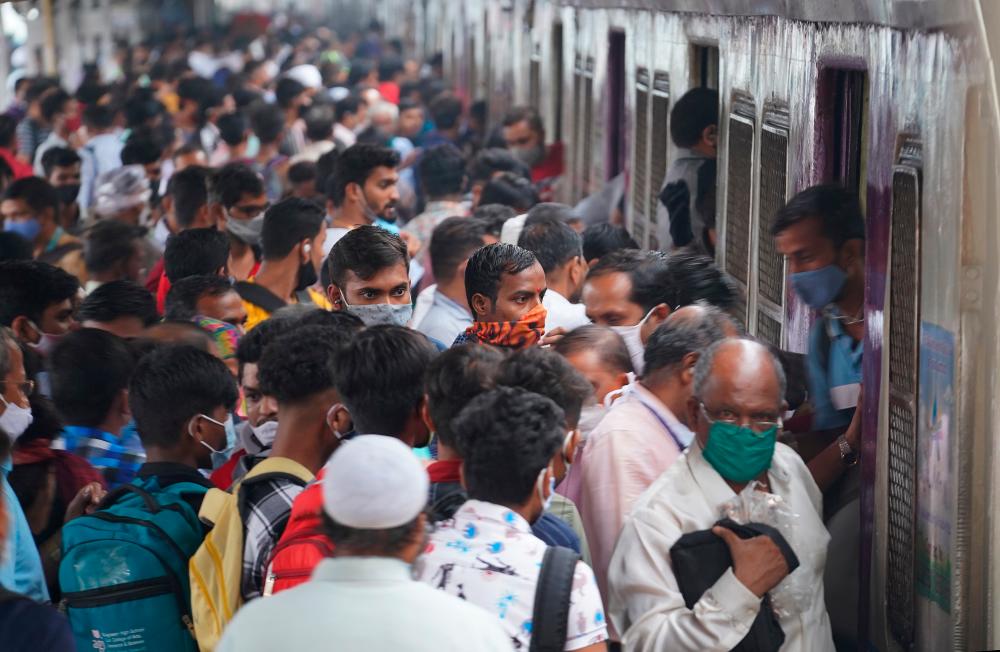 Commuters disembark from a suburban train at a railway station, amidst the coronavirus disease (Covid-19) pandemic, in Mumbai, India, December 1, 2021. REUTERSpix