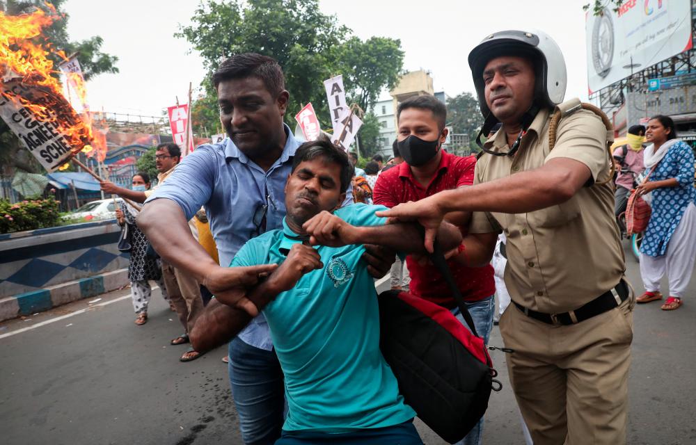 Police detain a demonstrator during a protest against Agnipath scheme for recruiting personnel in the armed forces, in Kolkata, India, June 18, 2022. REUTERSpix