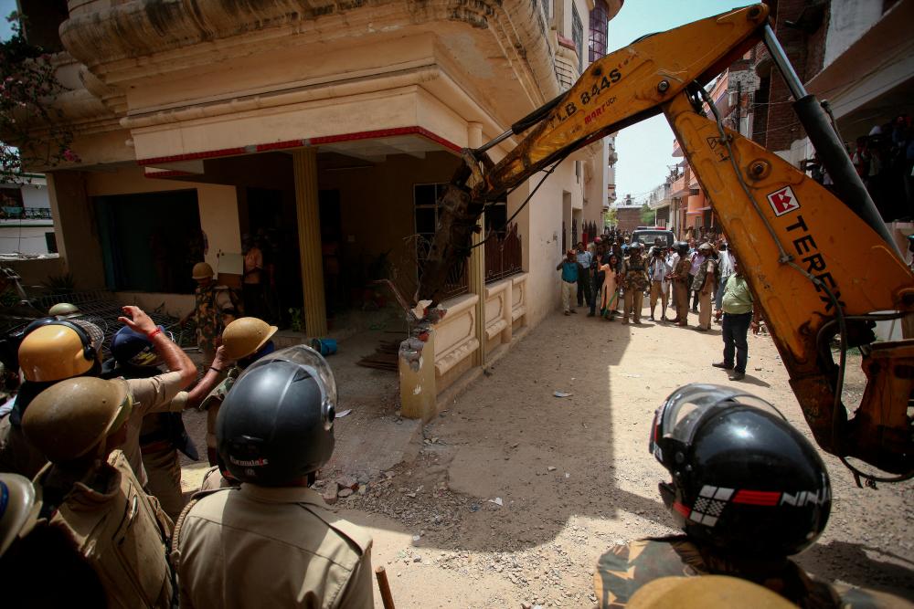 Heavy equipment is used to demolish the house of a Muslim man that Uttar Pradesh state authorities accuse of being involved in riots last week, that erupted following comments about the Prophet Mohammed by India's ruling Bharatiya Janata Party (BJP) members, in Prayagraj, India, June 12, 2022. Authorities claim the house was illegally built. REUTERSpix