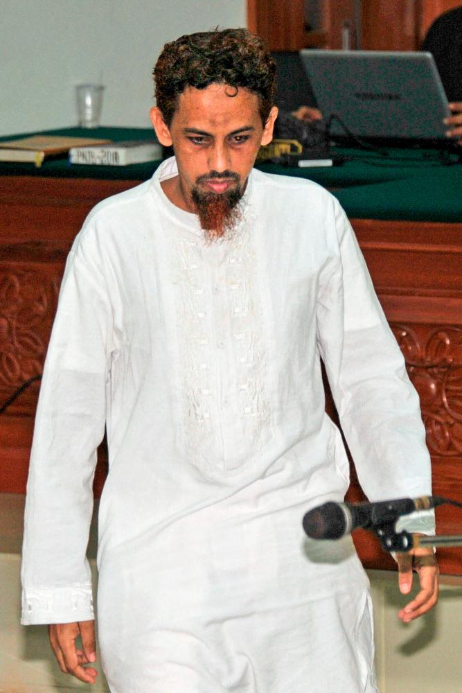 This picture taken on June 21, 2012 shows Indonesian terror suspect Umar Patek arrives at a Jakarta court to hear the judge's verdict. AFPPIX