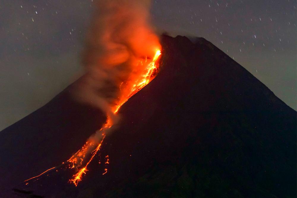 Mount Merapi volcano spews lava from its crater as seen from Sleman in Yogyakarta early on March 18, 2023. AFPPIX