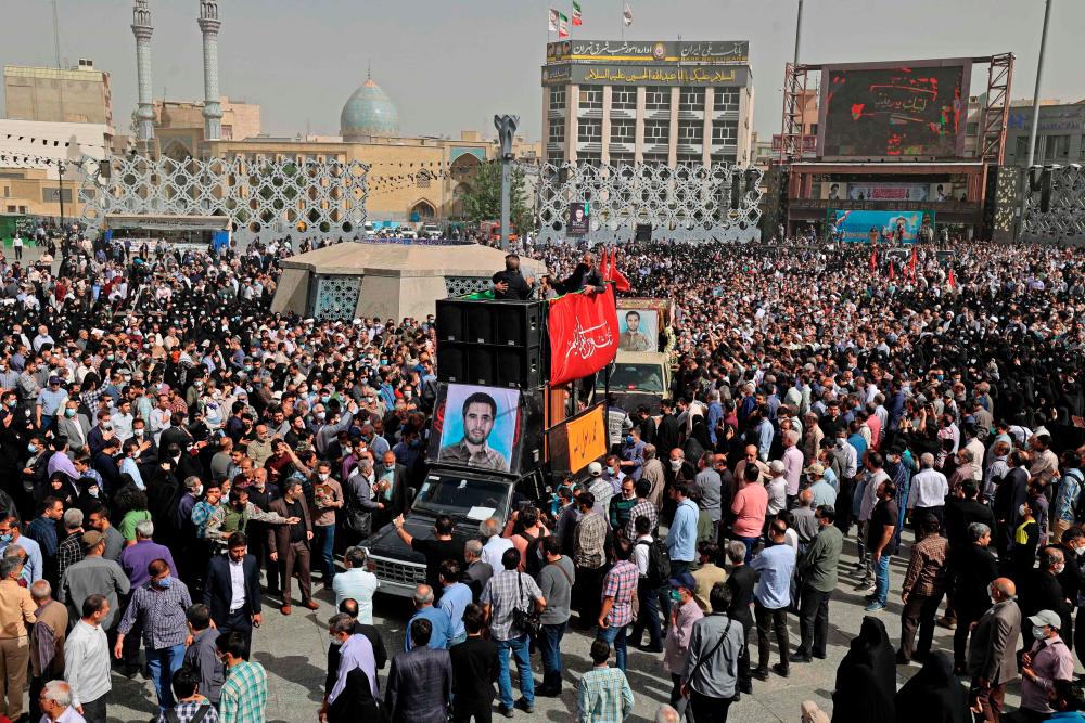 Mourners gather around the coffin of Iran's Revolutionary Guards colonel Sayyad Khodai during a funeral procession at Imam Hussein square in the capital Tehran, on May 24, 2022. AFPPIX