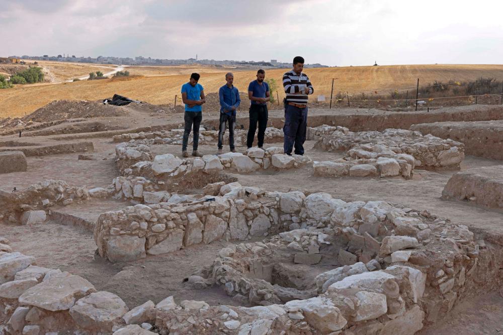 Muslim Palestinian workers of Israel’s Antiquities Authority pray amid the remains of a recently discovered ancient mosque, which dates back to the early Islamic period, in the Bedouin town of Rahat in Israel’s southern Negev desert on June 22, 2022. AFPPIX